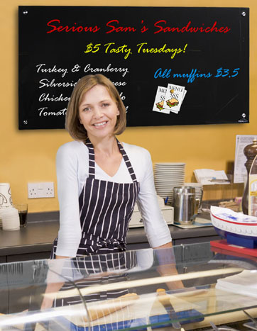 Woman standing at counter in restaurant smiling